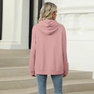 Detailed back view of a casual pink hooded sweatshirt for women in lifestyle setting