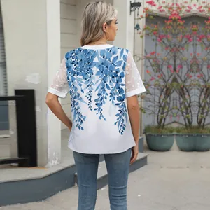 Back view of a white chiffon blouse with elegant blue floral print and floral lace sleeves.