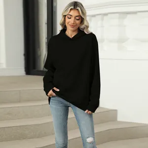Close-up of a casual black oversized hooded sweatshirt with a large front pocket