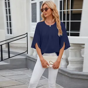 Detail view of a loose navy blue chiffon blouse with round neck and half sleeves