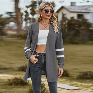 Casual women's grey open front knit cardigan with white stripes on long sleeves outdoor