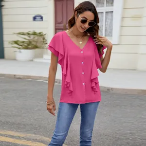 Detail of pink ruffle sleeve button-up blouse shown on a model outdoors.