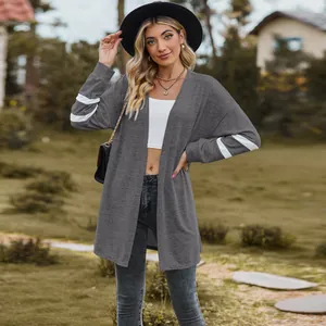 Casual grey long-sleeved knitted cardigan with white stripe detail in outdoor setting