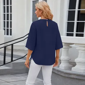 Back view of women's navy blue loose chiffon blouse with keyhole button closure.