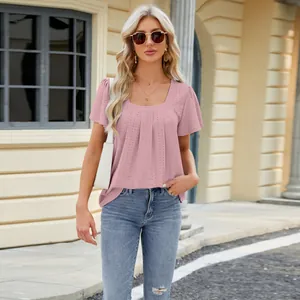 Elegant pink square neck eyelet top with pleated details and short sleeves outdoors