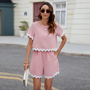 Full view of women's pink two-piece summer set featuring elegant white scalloped trim