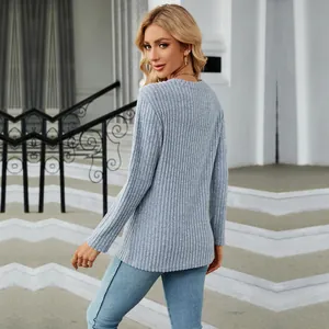 Back view of a women's light blue ribbed long-sleeve top with a tulip hem detail.