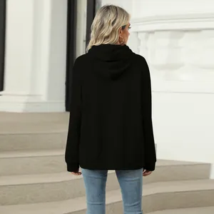 Detailed back view of a black women's oversized casual hoodie with a hood and cuffs