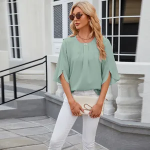 Detailed view of sage green chiffon blouse with pleated neckline and split sleeves