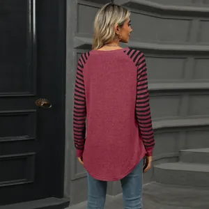 Back view of women's colorblock striped long sleeve t-shirt with curved swallowtail hem