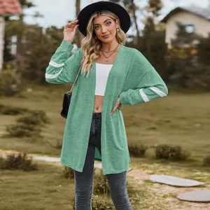 Detail view of a green long-sleeved knitted cardigan with white sleeve stripes
