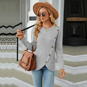 Close-up of women's grey ribbed long sleeve top featuring tulip hem and button detail