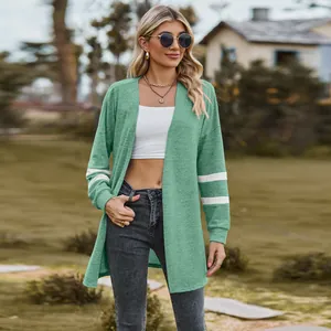 Detailed view of a green long-sleeved knitted cardigan with white stripes on the sleeves.