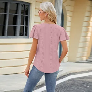Back view of a pink eyelet short sleeve t-shirt with flare sleeves and curved hem