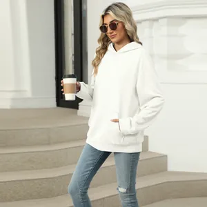 Lifestyle view of a white casual women's hoodie featuring a spacious front kangaroo pocket