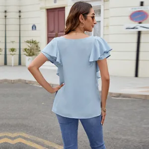 Back view of an elegant light blue blouse with flutter ruffle sleeves for women.