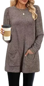 Detail view of women's loose ribbed knit tunic top with front pockets and puff sleeves.