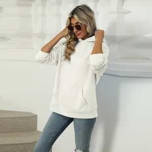 Close-up showing the fit of a casual white hoodie with kangaroo pocket and soft texture