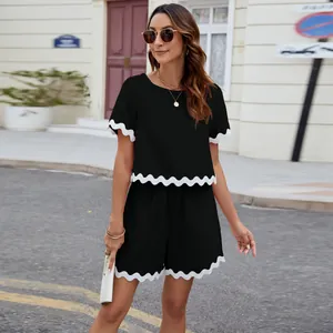 Black two-piece set with white scalloped trim featuring a short sleeve top and shorts