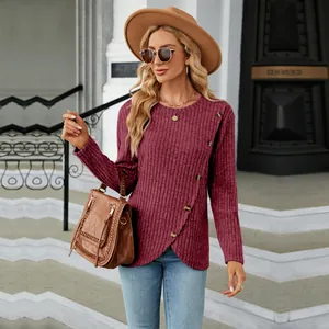 Detailed view of burgundy long-sleeve crewneck top with unique tulip hem and side buttons