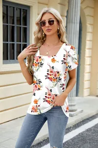 Model wearing a floral print square neck T-shirt with petal sleeves and sunglasses.