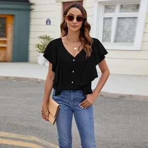 Detail of elegant black V-neck blouse featuring ruffled sleeves and button closure