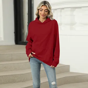 Fashionable women's oversized solid red hoodie with a kangaroo pocket for casual wear.
