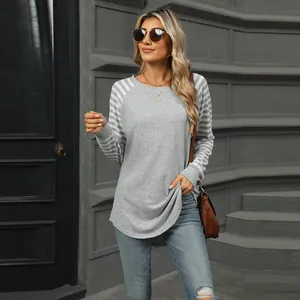 Woman wearing gray color-block striped sleeve long sleeve t-shirt with crew neck design