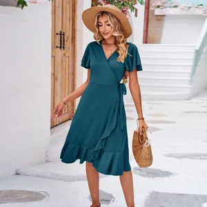 Full length view of teal V-neck wrap dress with short sleeves and ruffled irregular hem