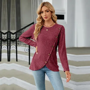 Detailed view of women's long sleeve ribbed top with button accents and tulip hem
