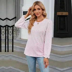 Full-body view of a stylish floral long-sleeve top paired with jeans in an outdoor setting