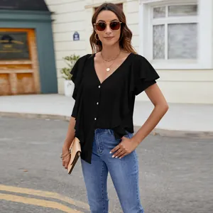 Detail shot of a black ruffle sleeve blouse with button-down front in a street setting