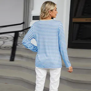 Back view of a casual blue and white striped long sleeve T-shirt for women in urban setting