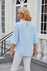 Back view of light blue loose chiffon blouse with round neck and keyhole detail
