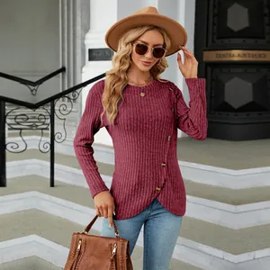 Close-up of women's ribbed burgundy top with unique tulip hem and button detail.