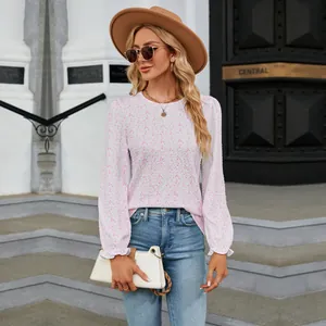 Detailed shot of a floral print long sleeve top with a round neck in a street setting