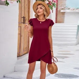 Summer wine red flutter sleeve mini dress with wrap hem detail shown in an outdoor setting