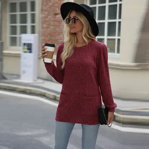 Detailed shot of maroon ribbed knit top featuring front pockets and puff sleeves