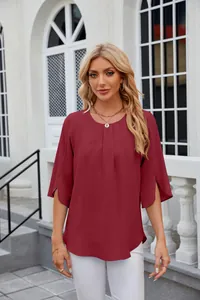 Detail view of a burgundy chiffon blouse featuring a round neck and pleated front design.