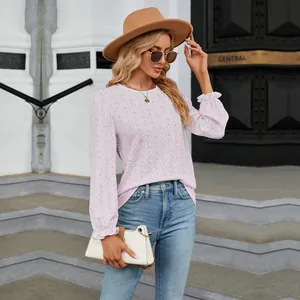 Elegant pink floral crew neck long sleeve top with smocked texture detail.