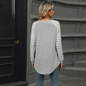 Back view of a women's striped raglan sleeve t-shirt featuring a curved swallowtail hem