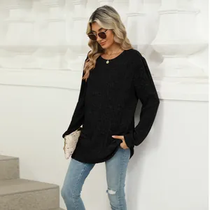 Detail of black ribbed knit top with round neck, pockets and puff sleeves for women