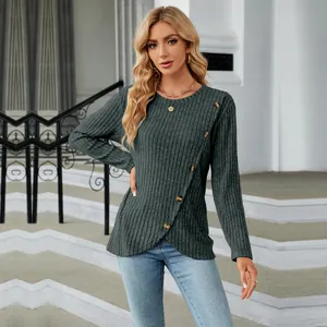 Detailed view of women's ribbed knit long sleeve top featuring tulip hem and button accents