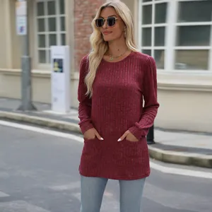 Close-up of maroon ribbed top featuring functional front pockets and stylish bubble sleeves.