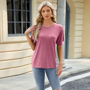 Outdoor street style view of a mauve raglan sleeve t-shirt with decorative button details