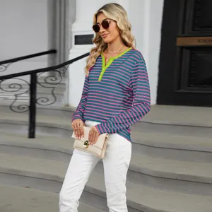 Detailed view of women's V-neck striped top with vibrant green color block trim