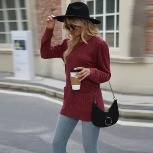 Stylish burgundy bubble sleeve knit top with front pockets in an urban lifestyle shot
