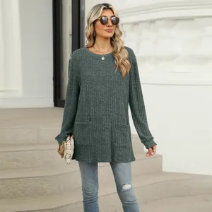 Casual grey long sleeve ribbed top with pockets worn by model in outdoor setting