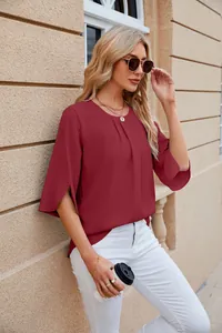 Close-up view of elegant burgundy chiffon blouse featuring unique flared slit sleeves