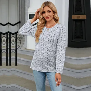 Woman wearing a floral long sleeve round neck top in a modern outdoor setting
